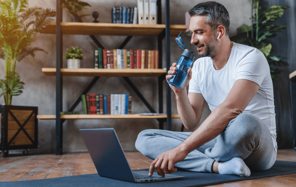 Man drinking from water bottle after working out