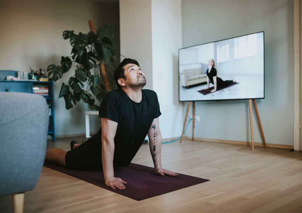 Man practicing yoga pose on floor mat