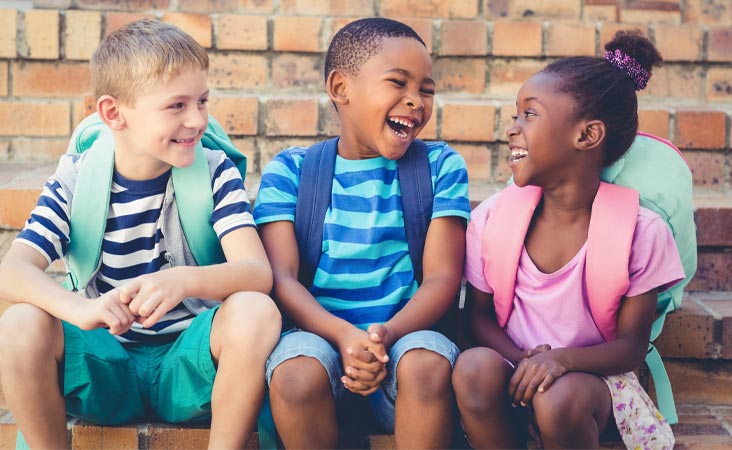 Group of children sitting together laughing