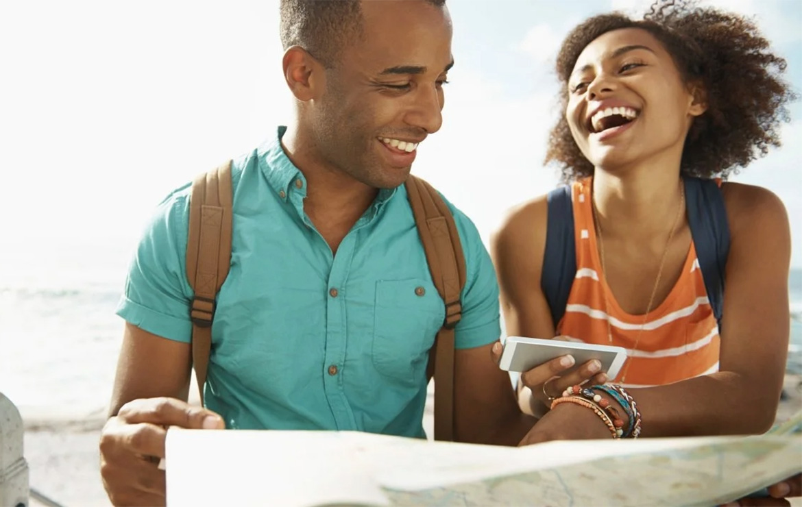 Couple at beach looking at map