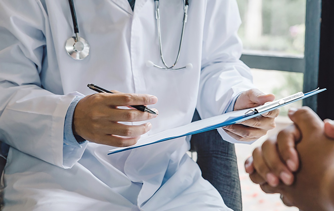 Doctor holding pen and clipboard