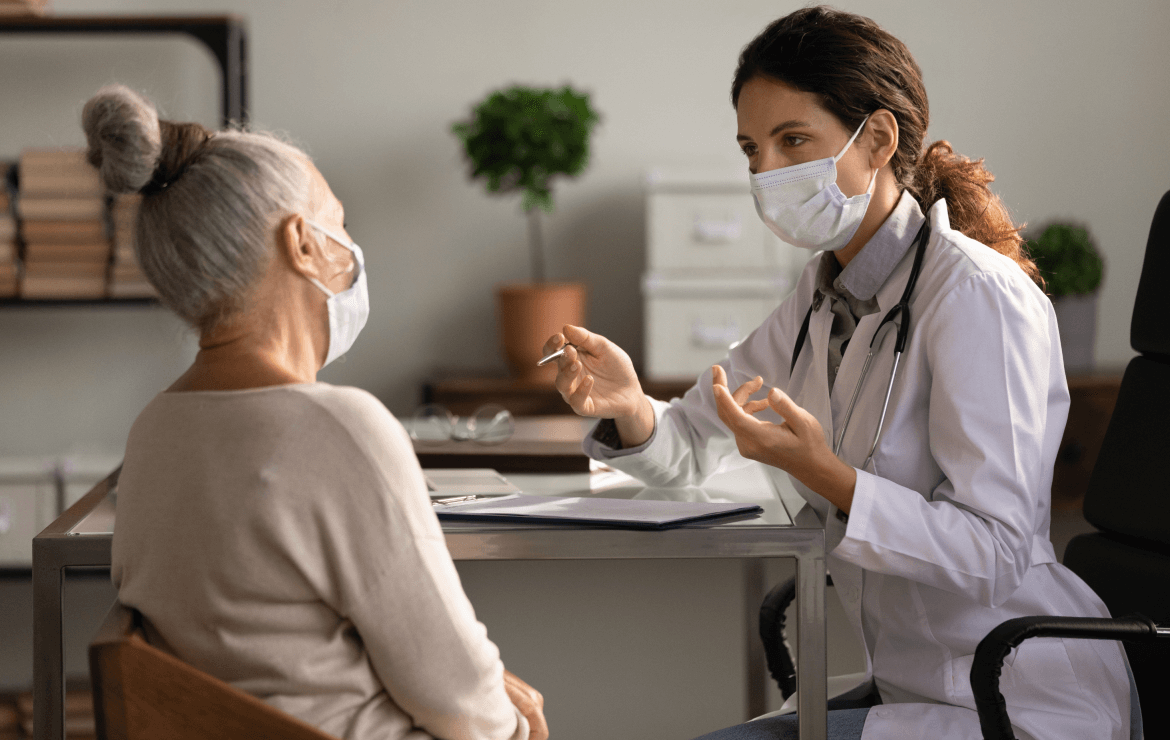 Doctor speaking with older patient in office