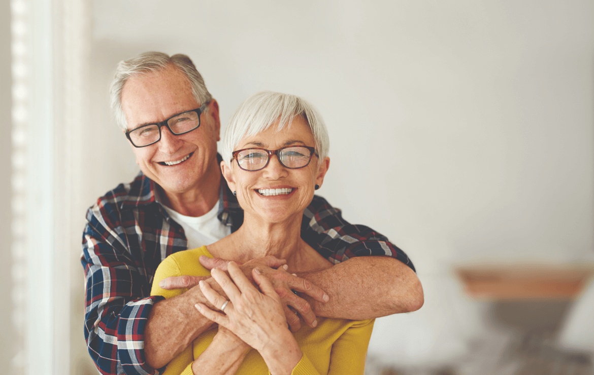 Portrait of older senior couple smiling and hugging