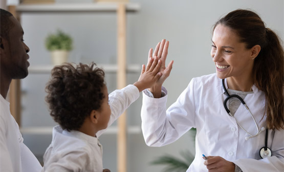 Doctor high fiving child