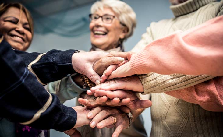 Group of women putting hands together in a circle